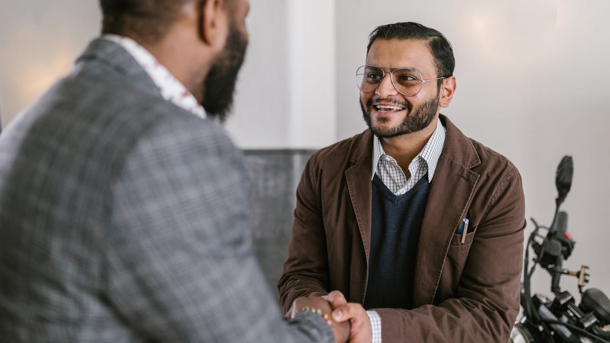 Two Indian businessmen shaking hands — partnership firm agreement